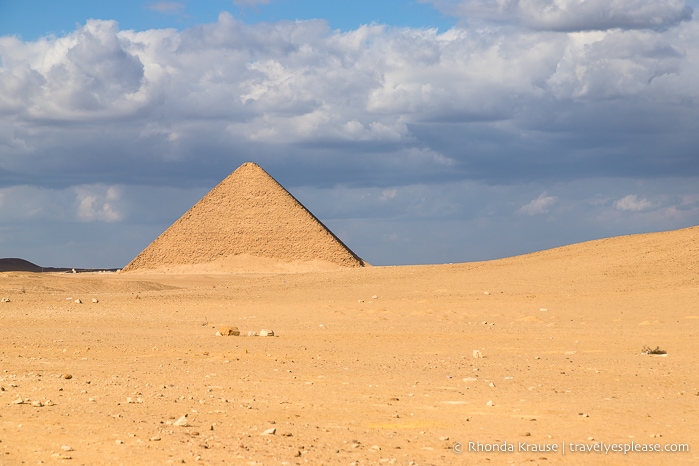 The Red Pyramid surrounded by sand.